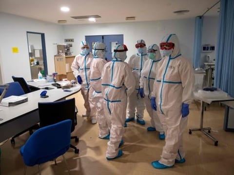 Healthcare workers chat at the Intensive Care Unit (ICU) of the Severo Ochoa University Hospital in Leganes on October 16, 2020. 