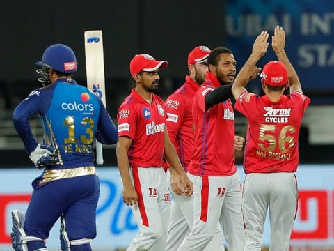 File photo: Kings XI Punjab players celebrate the wicket of Quinton de Kock of Mumbai Indians. 