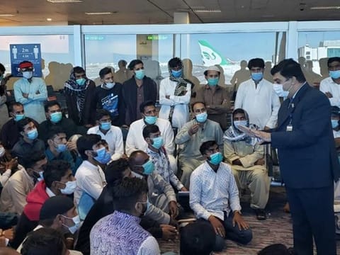 Pakistan Consul General in Dubai Ahmed Amjad Ali talking to stranded Pakistani passengers at the Dubai International Airport. The consulate has warned job seekers not to travel to Dubai on tourist visas. 