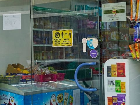 Shops have been mandated to display stickers reminding customers of the need for social distancing 