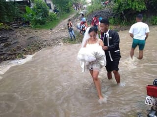 Philippines: Couple's love takes internet by storm as pictures of them braving floods to get married go viral