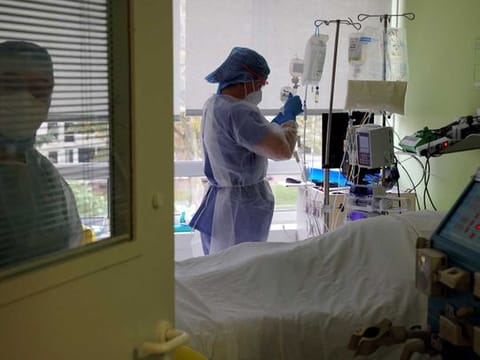 Nurses wearing protective masks and protective suits, work in the Intensive Care Unit (ICU) where patients suffering from the coronavirus disease (COVID-19) are treated at the Le Bois private hospital in Lille, France, October 28, 2020.