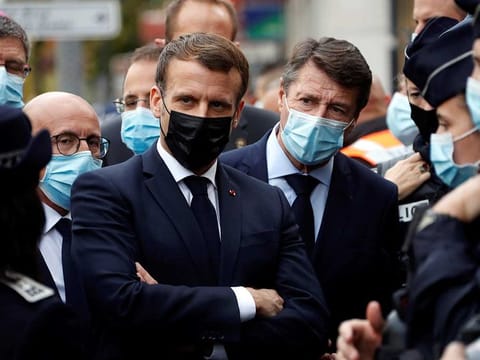 French President Emmanuel Macron, and Nice mayor Christian Estrosi , right, meet police officers after a knife attack at Notre Dame church in Nice, southern France, Thursday, Oct. 29, 2020. 
