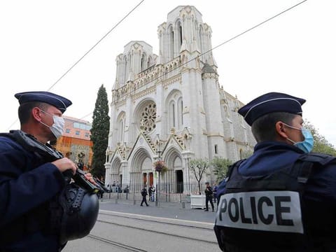 French policemen stand guard the site of a knife attack at the Basilica of Notre-Dame de Nice in Nice on October 29, 2020, as forensics officers prepare to enter.