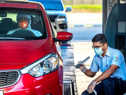 A Tasjeel pilot at a drive-through express service at Sharjah Auto Village. 
