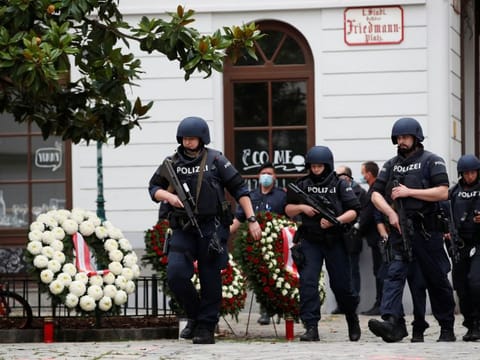 Police officers walk at the site of wreath laying ceremony after exchanges of gunfire in Vienna on Tuesday. 
