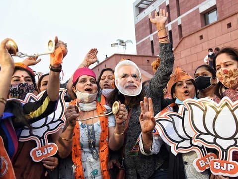 BJP supporters celebrate the party's good performance in the Bihar elections at the BJP headquarters in New Delhi on Tuesday, November 10, 2020. 