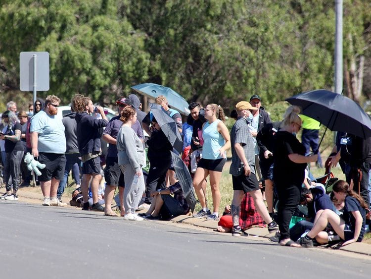 People are seen queuing at a COVID-19 testing site