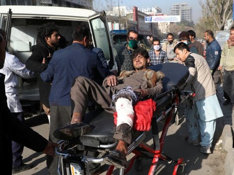 An injured man is carried to a hospital after rockets hit residential areas in Kabul, Afghanistan November 21, 2020.