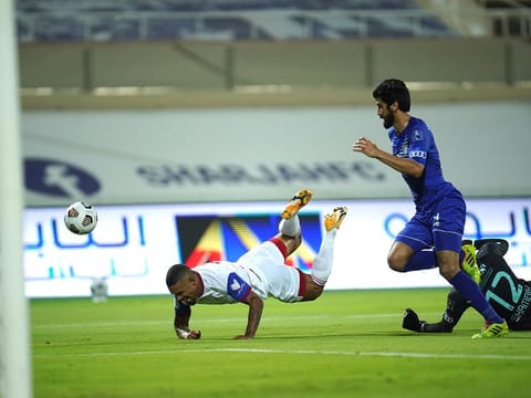 Sharjah Club's Welliton Soares (going down) struck for his team in a 2-0 away win over Khor Fakkan. 