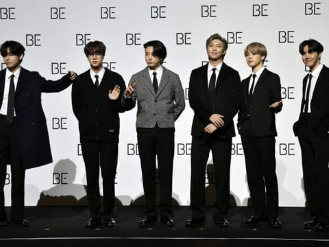 South Korean K-pop boy band BTS members (L to R) V, Jin, Jung Kook, RM, Jimin and J-Hope pose for a photo session during a press conference on BTS new album 'BE (Deluxe Edition)' in Seoul on November 20, 2020.