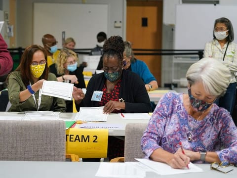 Workers recount election ballots by hand in Gwinnett County, Georgia on Friday, Nov. 13, 2020.