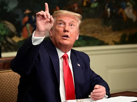 US President Donald Trump gestures as he participates in a Thanksgiving video teleconference with members of the military forces at the White House in Washington, U.S., November 26, 2020.