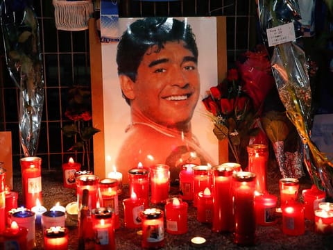Candles and flowers are seen outside the San Paolo stadium commemorating soccer legend Diego Maradona in Naples on Thursday.