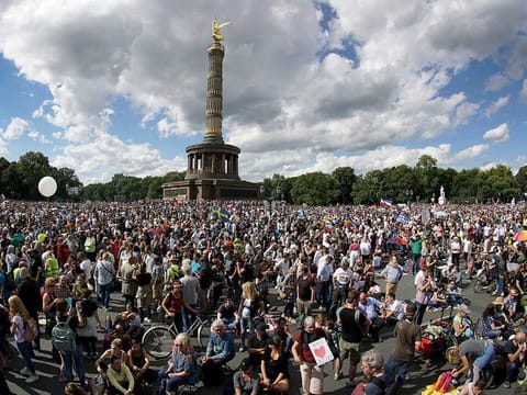 In this August 29, 2020 file photo, people gather at the Victory Column as they attend a protest rally in Berlin, Germany against new coronavirus restrictions in Germany. The country has hit another grim milestone in the coronavirus pandemic ticking above 2 million confirmed cases. 