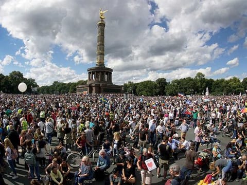 In this August 29, 2020 file photo, people gather at the Victory Column as they attend a protest rally in Berlin, Germany against new coronavirus restrictions in Germany. The country has hit another grim milestone in the coronavirus pandemic ticking above 2 million confirmed cases. 