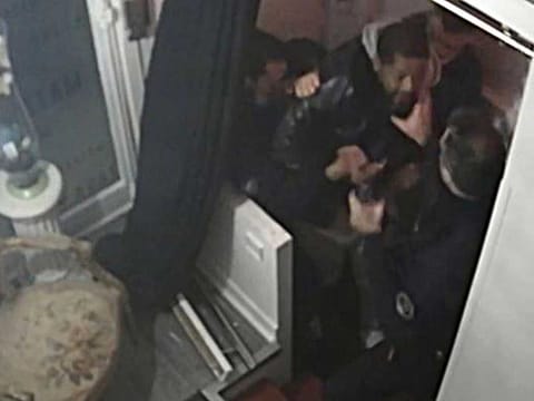 This video grab taken on November 27, 2020 from an AFP video shows CCTV camera footage, widely distributed on social networks, showing producer Michel Zecler being beaten up by police officers at the entrance of a music studio in the 17th arrondissement of Paris on November 21, 2020. 