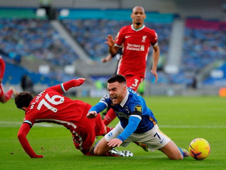 Liverpool's Neco Williams fouls Brighton's Irish striker Aaron Connolly for a penalty