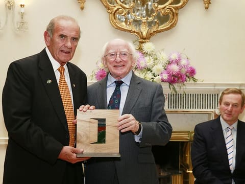 Colm McLoughlin accepting the Irish Presidential Distinguised Service Award from the Irish President, Michael D Higgins while An Taoiseach Enda Kenny looks on.