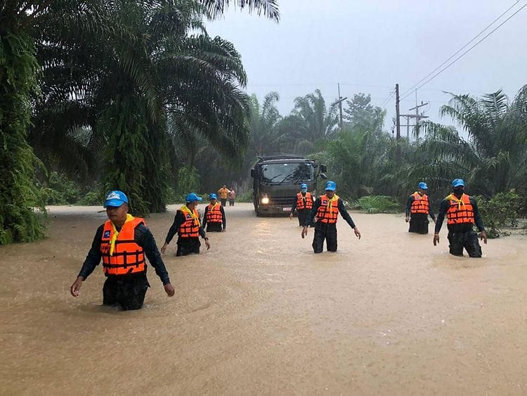 Security forces wading through flood waters