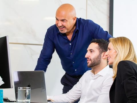 Dariush Soudi (left) with others at his office.