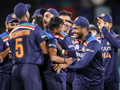 India's captain Virat Kohli (C) celebrates with teammate T Natarajan after he dismissed Australia's Glenn Maxwell during the 1st T20 match at Manuka Oval in Canberra on December 4, 2020. 