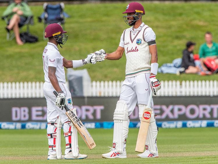 West Indies' Jermaine Blackwood (L) and Roston Chase touch gloves during the third day of the first Test cricket match between New Zealand and West Indies