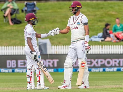 West Indies' Jermaine Blackwood  (L) and Roston Chase touch gloves during the third day of the first Test cricket match between New Zealand and West Indies