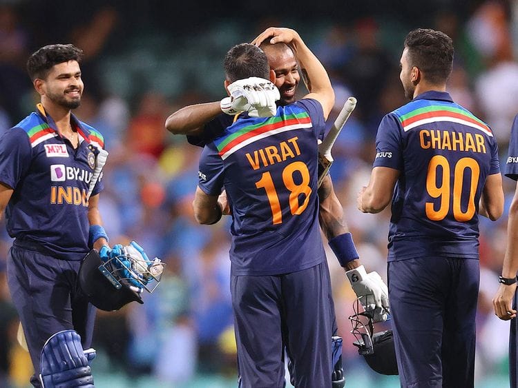 Virat Kohli (2nd L) gives a hug to a teammate Hardik Pandya