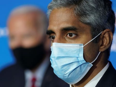 US President-elect Joe Biden listens with Dr. Vivek Murphy, Biden's nominee to be US Surgeon General, during a news conference at Biden's transition headquarters in Wilmington, Delaware, U.S., December 8, 2020. 