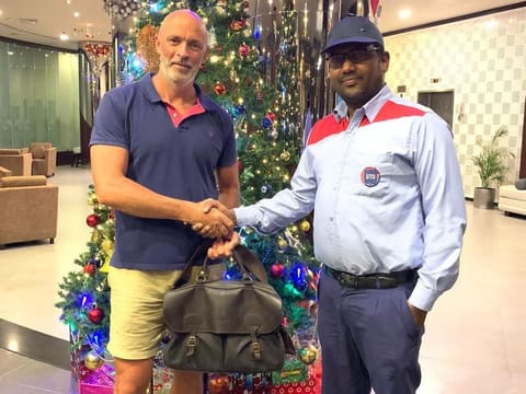 A grateful Alan Gardner specially took a picture with taxi driver Firos CK to share his story