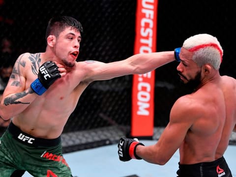 Brandon Moreno of Mexico and Deiveson Figueiredo fight during UFC 256 