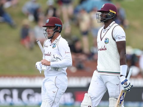 West Indies batsmen Jason Holder (R) and Joshua Da Silva leave the field as bad light stops play on day three of the second cricket Test match between New Zealand and the West Indies 
