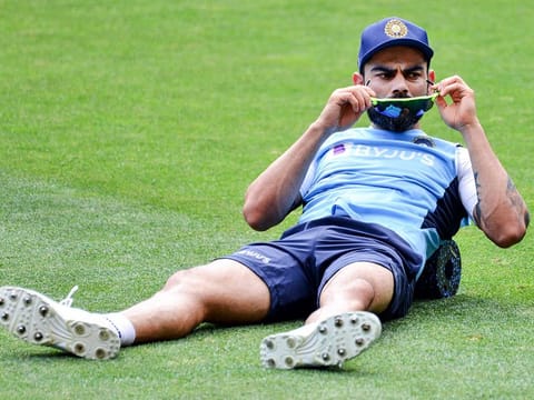 India's captain Virat Kohli does stretching exercises during a training session at Adelaide Oval on December 15, 2020, ahead of the first Test cricket match between Australia and India. 