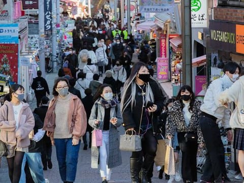 People wearing face masks walk through a famed shopping street in the Harajuku neighbourhood in Tokyo on Thursday, Dec. 17, 2020. 
