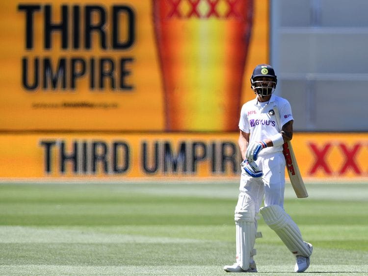 India's Virat Kohli waits as he walks off as the third umpire checks the catch that takes Kohli's wicket for 4 runs against Australia