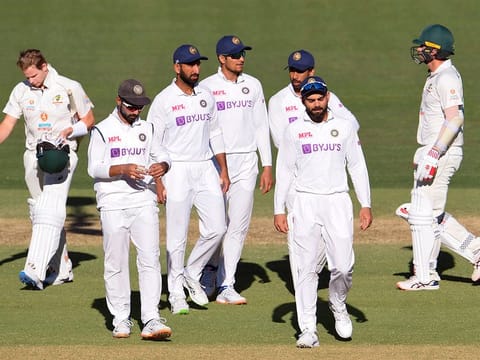 India's captain Virat Kohli (2/R) leads his players off the field after their loss to Australia on the third day of the first cricket Test match in Adelaide. 