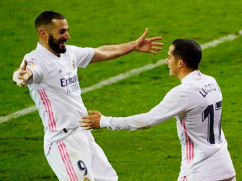 Real Madrid's Lucas Vazquez celebrates scoring their third goal with Karim Benzema.