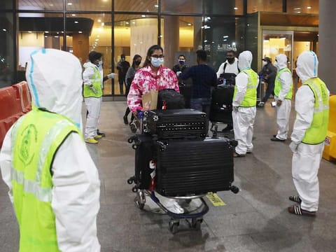 Passengers wearing protective face masks arrive at Chhatrapati Shivaji Maharaj International Airport after India cancelled all flights from the UK over fears of a new strain of the coronavirus disease (COVID-19), in Mumbai, India, December 22, 2020. 