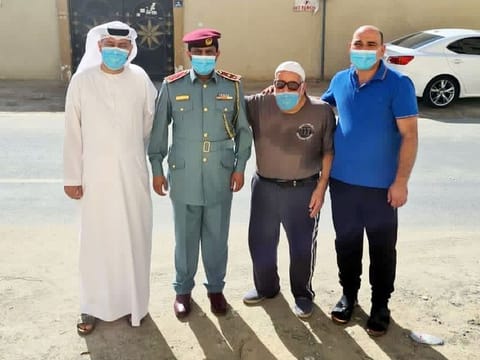 Ajman Police officers with the elderly man.