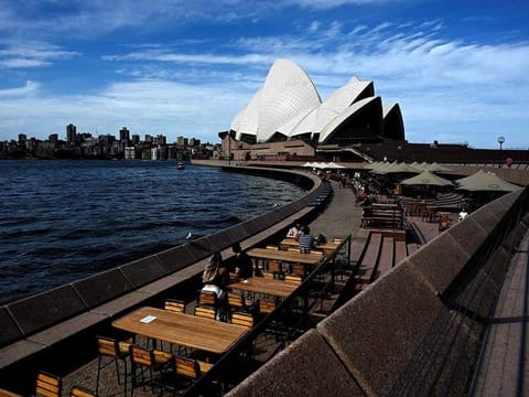 This general view shows seating for restaurants mostly empty along Sydney Harbour, usually packed with locals and tourists on Christmas Eve but now quiet due to COVID-19 coronavirus concerns, in Sydney.