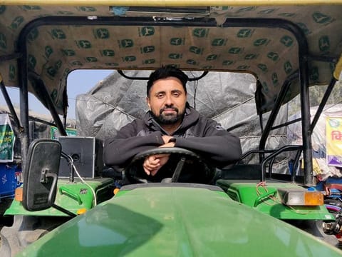 Bhavjit Singh, 38, a computer professional, poses on a tractor at the site of a protest against new farm laws at Singhu border near Delhi, India, December 14, 2020. 