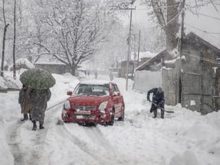 In pictures: Heavy snowfall disrupts life in Kashmir