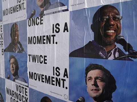 Campaign ads for Jon Ossoff and Raphael Warnock are seen on a wall  near the John Lewis mural the day after the U.S. Senate runoff elections in Atlanta, Georgia, U.S., January 6, 2021. 