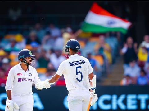 File photo: India's Washington Sundar (R) is congratulated by Shardul Thakur (L) after reaching his half century vs Australia at the Gabba in Brisbane on January 17, 2021.  