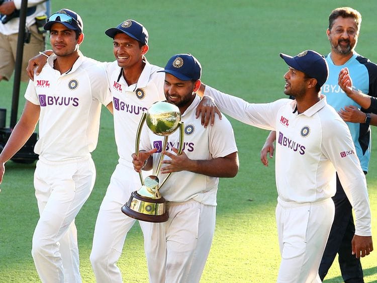 India's Rishabh Pant carries the Border-Gavaskar Trophy as he celebrates with his teammates after defeating Australia by three wickets on the final day of the fourth cricket test at the Gabba, Brisbane, Australia.