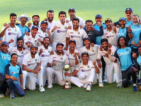 Indian players celebrate with their trophy after defeating Australia by three wickets on the final day of the fourth Test at the Gabba, Brisbane. 