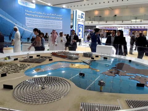 Visitors at the model of a solar project of Masdar at the Masdar pavilion at Abu Dhabi Sustainability Week during an earlier edition. The event is being held virtually for the first time this year.