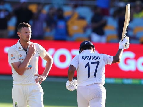 Australia's Josh Hazlewood reacts as India's Rishabh Pant, right, celebrates after hitting the winning runs to defeat Australia by three wickets on the final day of the fourth Test at the Gabba, Brisbane. 