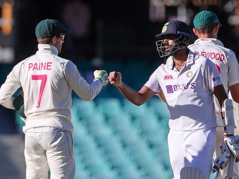 India's Ravichandran Ashwin (right) fist-bumping with Australia's captain Tim Paine at the end of the third cricket Test in Sydney on January 11, 2021. Paine apologised to Ashwin the next day for launching an ugly tirade, admitting he was "bitterly disappointed" in his own conduct. 